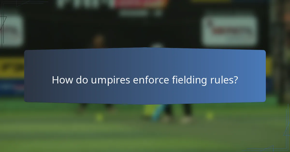 How do umpires enforce fielding rules?